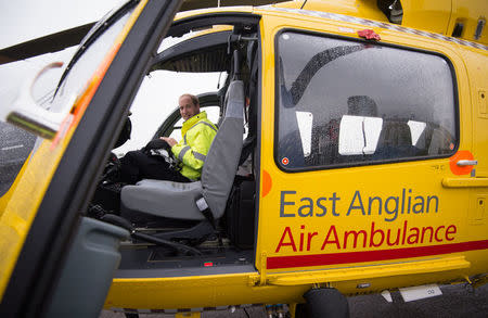 FILE PHOTO - Britain's Prince William sits in the cockpit of his helicopter as he begins his new job as a co-pilot with the East Anglian Air Ambulance (EAAA) at Cambridge Airport, Britain July 13, 2015. REUTERS/Stefan Rousseau/pool/File Photo