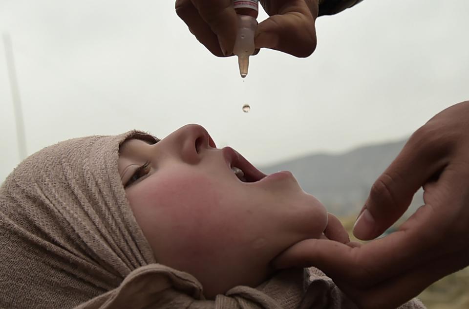 In this photo taken in 2017, an Afghan health worker administers the polio vaccine to a child during a vaccination campaign in Kabul. Afghanistan is among three countries that still have not eradicated polio. A vaccine was discovered by Jonas Salk in 1955 after the virus crippled and killed thousands around the world.