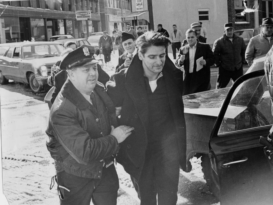 A police officer escorts a handcuffed Albert DeSalvo in February 1967.