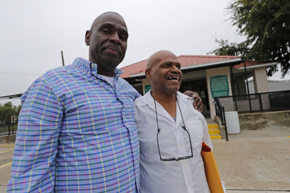 Elvis Brooks walks out of the Louisiana State Penitentiary at Angola with his brother Aaron Brooks, left, in Angola, La., Wednesday, Oct. 16, 2019. Elvis Brooks, who has spent two-thirds of his life in prison for a killing he always denied committing, pleaded guilty to manslaughter and was released. Since his arrest in 1977, Brooks has maintained that he's innocent. Innocence Project New Orleans attorneys say evidence that would have cleared him was withheld at trial. Prosecutors offered the plea agreement Tuesday which was accepted. (AP Photo/Gerald Herbert)