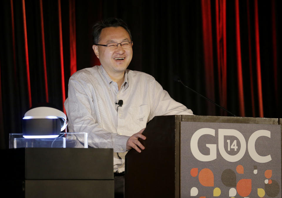 Shuhei Yoshida, president of Sony Computer Entertainment Worldwide Studios, speaks after unveiling the PlayStation 4 virtual reality headset Project Morpheus, pictured at left, at the Game Developers Conference 2014 in San Francisco, Tuesday, March 18, 2014. (AP Photo/Jeff Chiu)