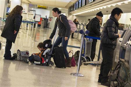 Travelers line up to check in to their flights at John F. Kennedy International Airport in New York, November 27, 2013. REUTERS/Lucas Jackson