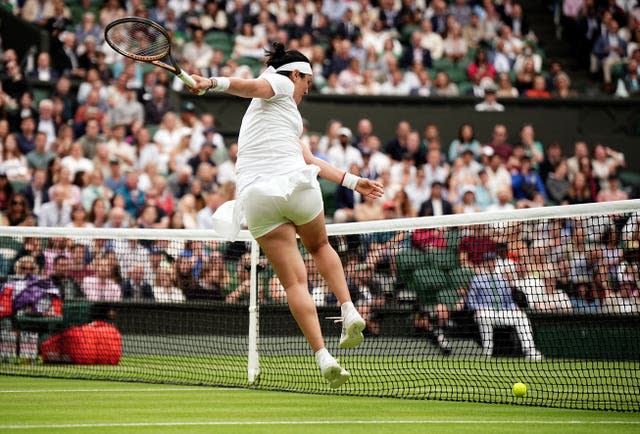 Ons Jabeur kicks the tennis ball into the net