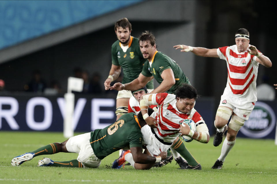 FILE - Japan's Keita Inagaki is tackled by South Africa's Siya Kolisi during the Rugby World Cup quarterfinal match at Tokyo Stadium between Japan and South Africa in Tokyo, Japan, on Oct. 20, 2019. Japan has been a fan favorite at the last two Rugby World Cups for its underdog victories over top-tier teams. (AP Photo/Mark Baker, File)