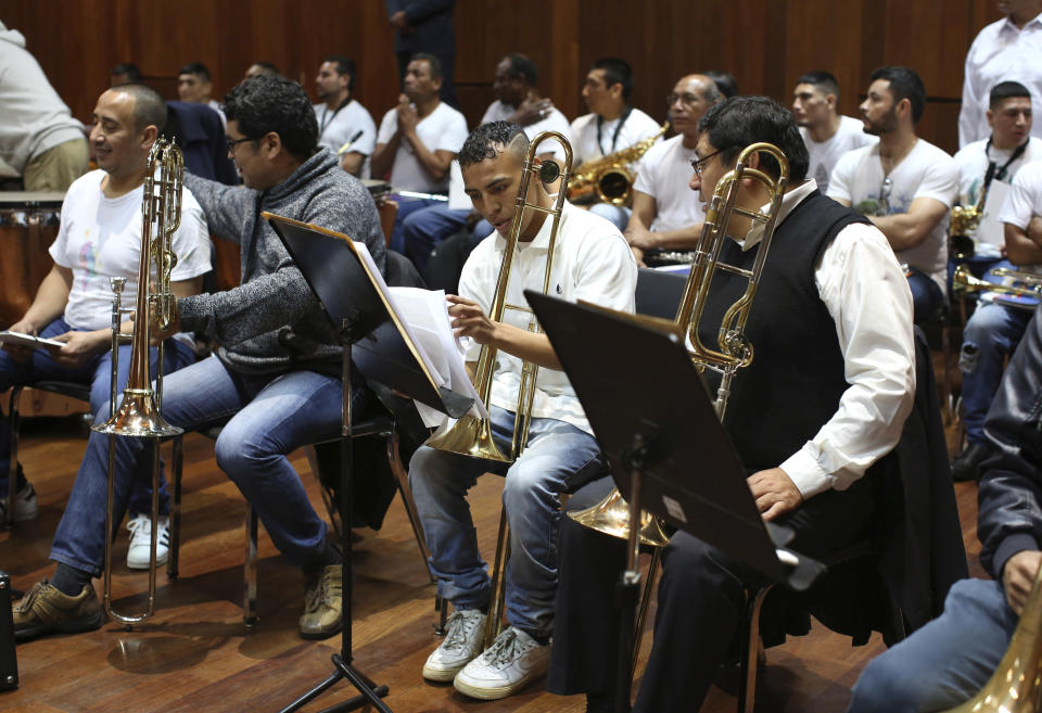 In this July 19, 2019 photo, inmates take their seats as they prepare to take part in a classical music session with the symphony orchestra as part of a pioneering project to rehabilitate criminals in Lima, Peru. In 2017, Peru’s prison service started music lessons for inmates, expanding on a similar national program for youth. (AP Photo/Martin Mejia)