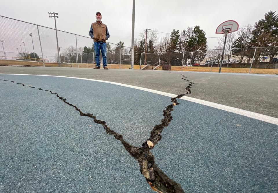 Steve Thomason of Greenville, looks at cracks in an aged basketball court in Gower Park in Greenville, S.C. Tuesday, January 31, 2023.  Thirteen recreation projects in South Carolina were the recipients of federal Land and Water Conservation Fund (LWCF) grants, including $500,000 of the $1,400,000 project at Gower Park to renovate tennis and basketball courts, parking, and add new basketball, pickleball, and tennis courts. 