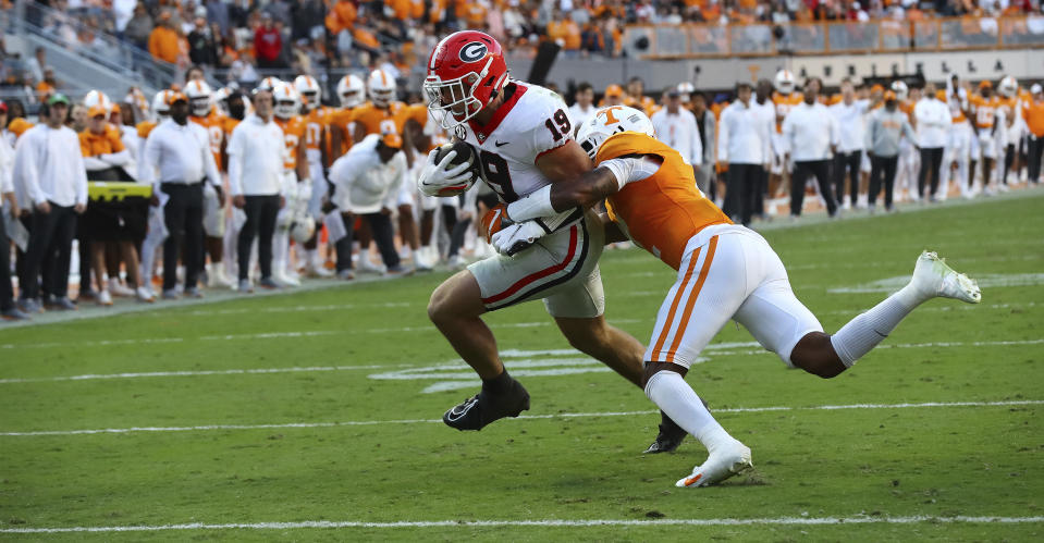 Georgia tight end Brock Bowers powers into the endzone past Tennessee defensive back Jaylen McCollough during the second quarter of an NCAA college football game, Saturday, Nov. 18, 2023, in Knoxville, Tenn. (Curtis Compton/Atlanta Journal-Constitution via AP)