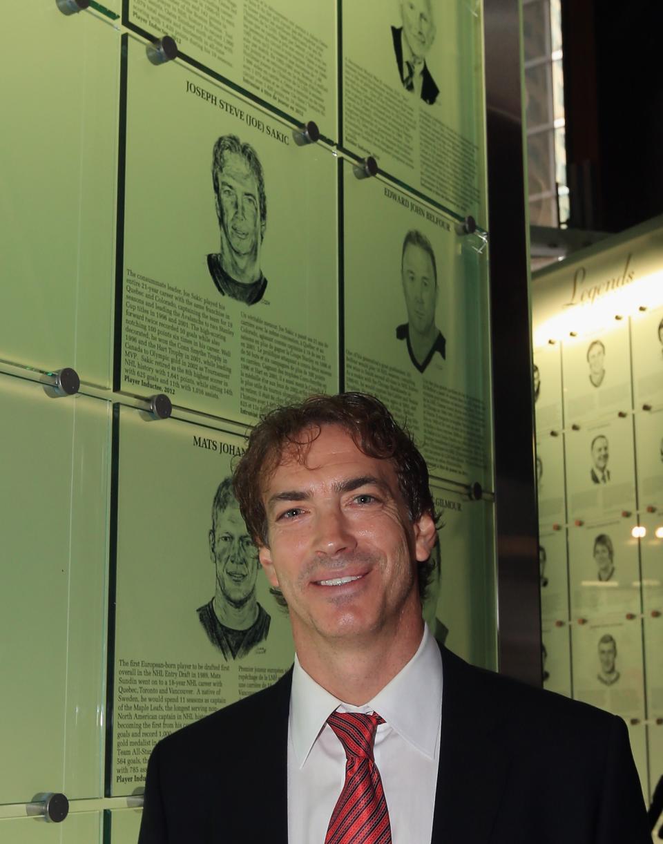 TORONTO, ON - NOVEMBER 12: Joe Sakic poses by his Hall of Fame plaque following a photo opportunity at the Hockey Hall of Fame on November 12, 2012 in Toronto, Canada. Sakic and three other former NHL players - Mats Sundin, Adam Oates and Pavel Bure - will be inducted into the Hall during a ceremony later today. (Photo by Bruce Bennett/Getty Images)