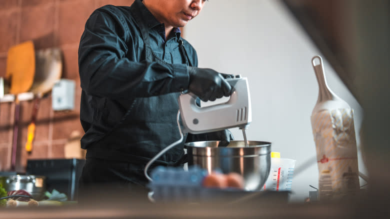 Man uses a hand mixer