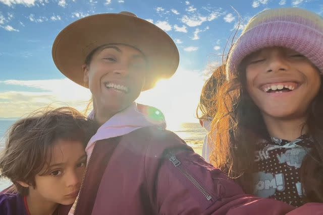 <p>Zoe Saldana /Instagram</p> Zoe Saldaña poses alongside sons Cy, Bowie and Zen on beach.