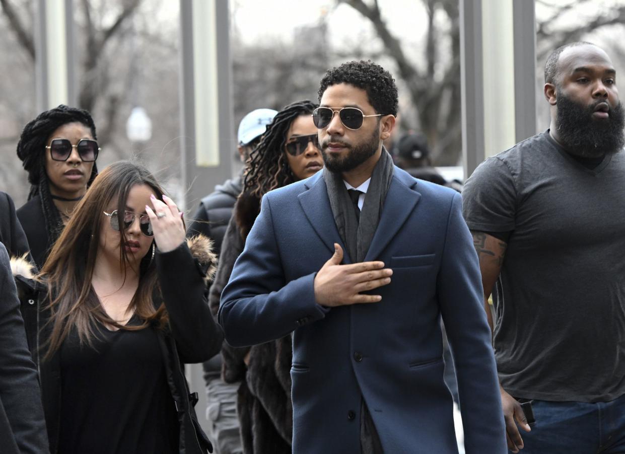 Empire actor Jussie Smollett, center, arrives at the Leighton Criminal Court Building for his hearing on Thursday, Mar. 14, 2019, in Chicago. Smollett is accused of lying to police about being the victim of a racist and homophobic attack by two men on Jan. 29 in downtown Chicago.