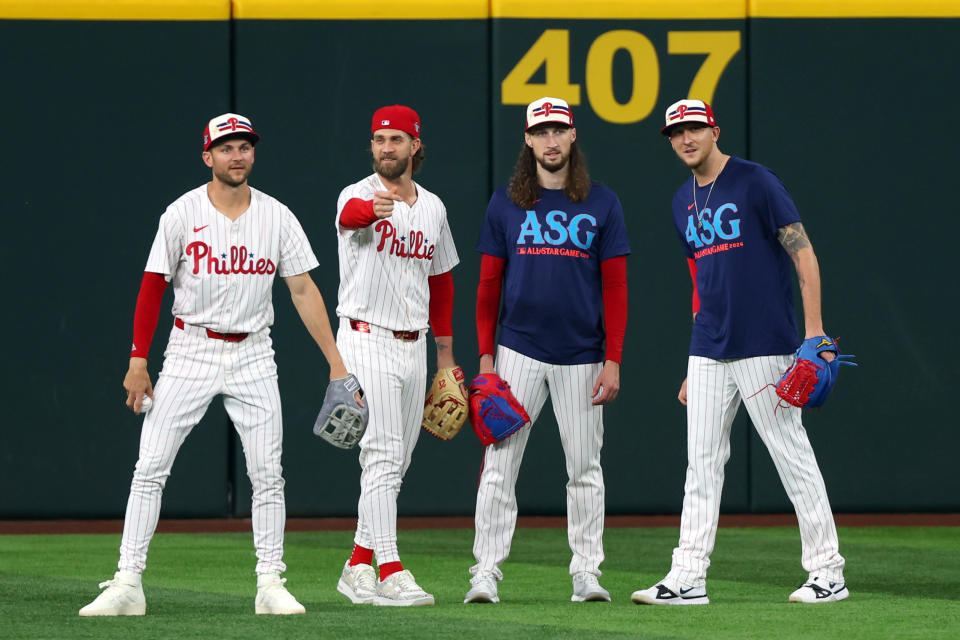 ARLINGTON, TEXAS - JULY 15: (L-R) Trea Turner #7, Bryce Harper #3, Matt Strahm #25 and Jeff Hoffman #23 of the Philadelphia Phillies look on from the outfield during Gatorade All-Star Workout Day at Globe Life Field on July 15, 2024 in Arlington, Texas. (Photo by Richard Rodriguez/Getty Images)