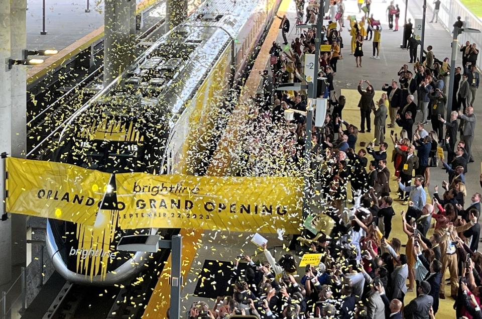 A Brightline train breaks the tape on Sept. 22, 2023, as it reaches the finish line of the inaugural run from South Florida to the Brightline terminal at Orlando International Airport.