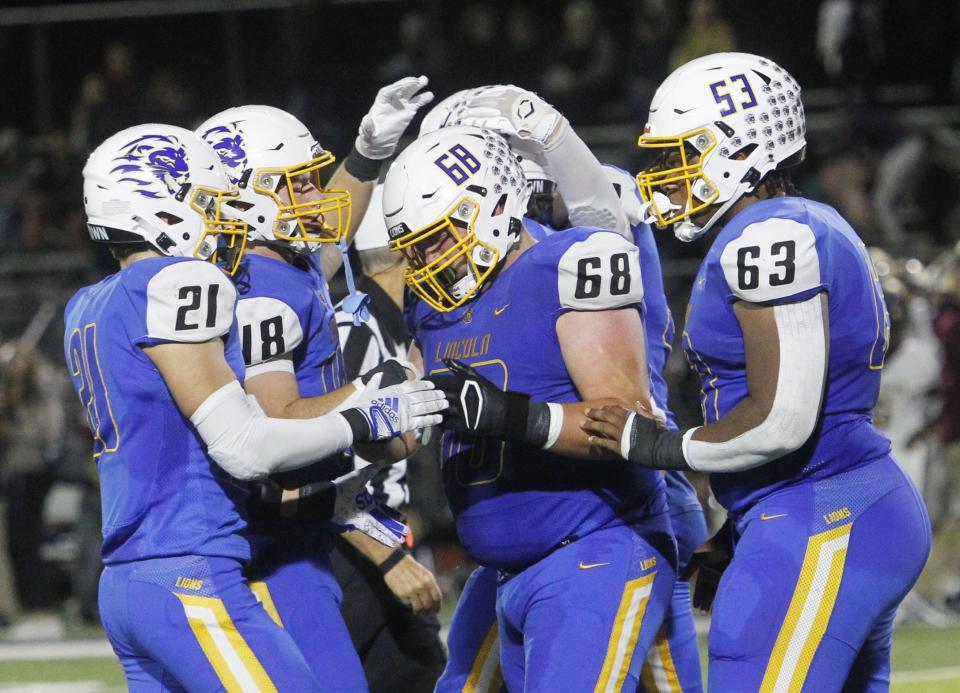 Gahanna's Gabe Bushelman (21) Dylan Scott (48) Ben Morris (68) and Isaac Perkins (63) celebrate their 38-24 win over New Albany on Sept. 30.  