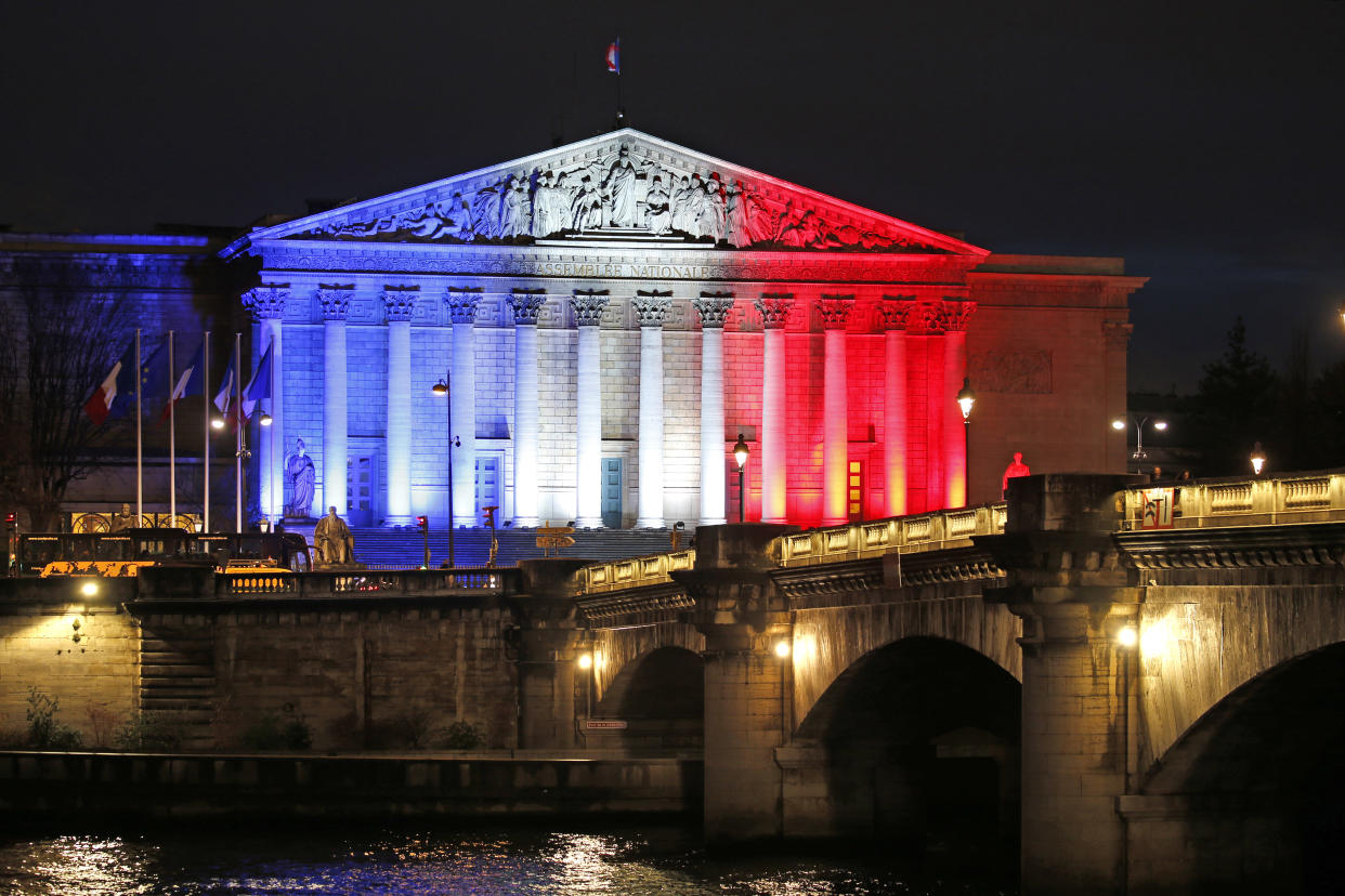 France's National Assembly is lit with the blue, white and red colours of the French flag in Paris. Photo: Charles Platiau/Reuters