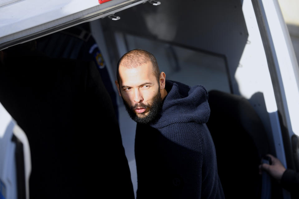 Former kickboxer Andrew Tate leaves court in Romania where he is accused of human trafficking and rape. (Getty Images)