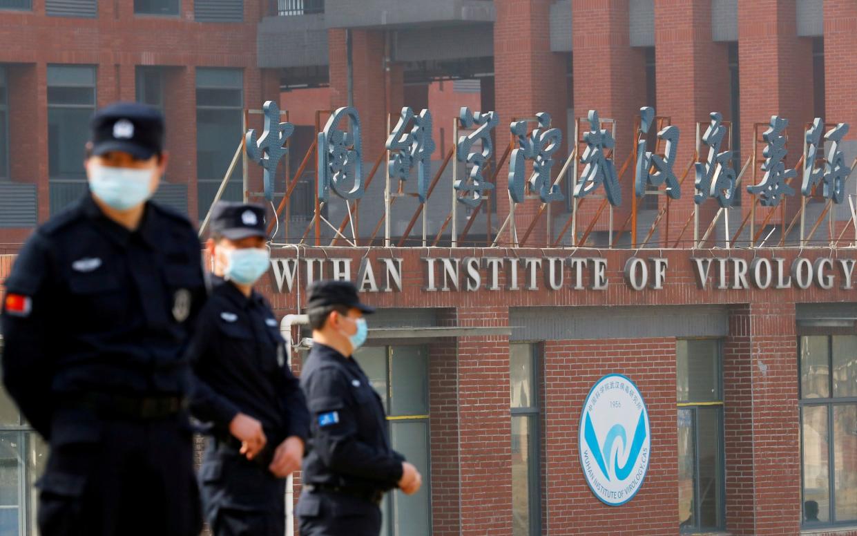Security personnel keep watch outside the Wuhan Institute of Virology - THOMAS PETER