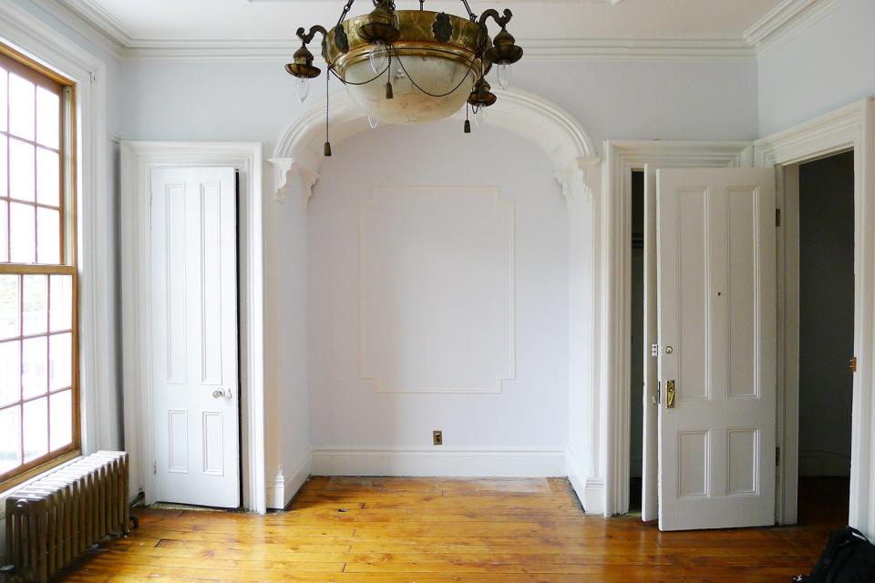 brooklyn brownstone living room with arch in it