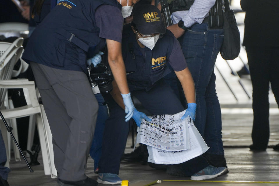 Agents from the Attorney General's office check June 25th general elections ballots during a raid at a temporary facility of the Supreme Electoral Tribunal, in Guatemala City, Tuesday, Sept. 12, 2023. (AP Photo/Moises Castillo)