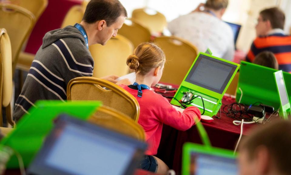 <span>Parents and children during a Raspberry Pi workshop in 2019.</span><span>Photograph: Mark Hawkins/Alamy</span>