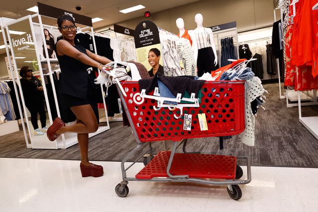 <p>Paul Morigi/Getty</p> Jenee Naylor checking out her collection at Target in Alexandria, Virginia