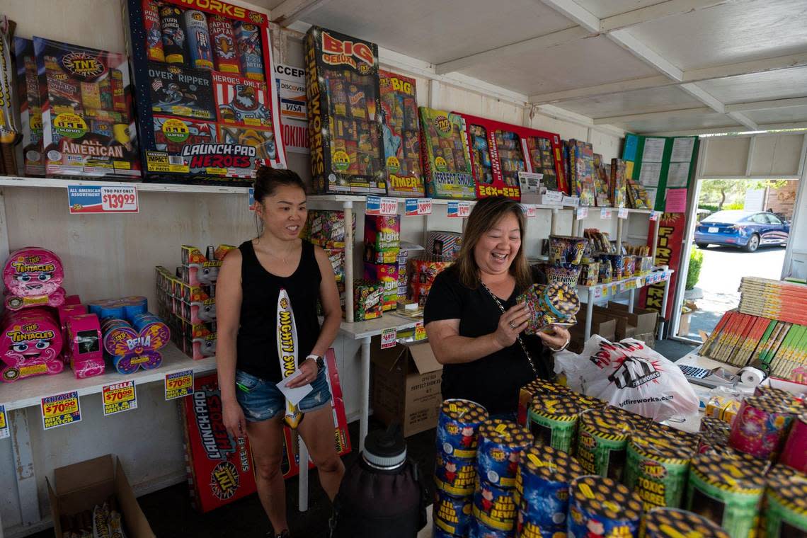 Sylvia Higa, right, and Michelle Claro sell fireworks in Sacramento to benefit the Sacramento Warlords Basketball Program on Tuesday, the first day of legal sales in the county.