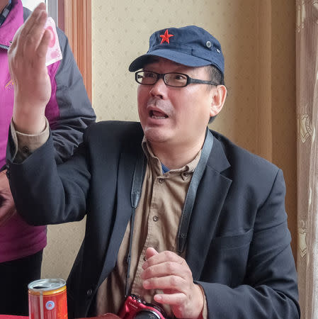 Yang Hengjun, author and former Chinese diplomat, who is now an Australian citizen, gestures in an unspecified location in Tibet, China, sometime in mid-July, 2014 in this social media image obtained by REUTERS