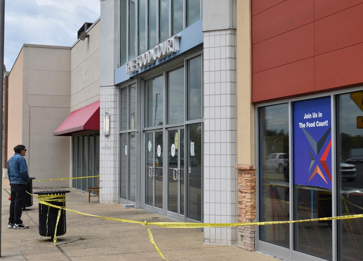 A man encounters a closed entrance at the fire-damaged Voorhees Town Center on April 24, 2024.