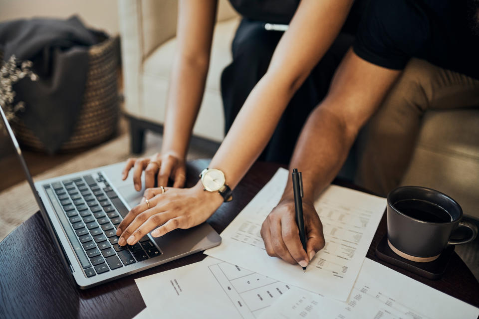 couple working together with paperwork and a laptop