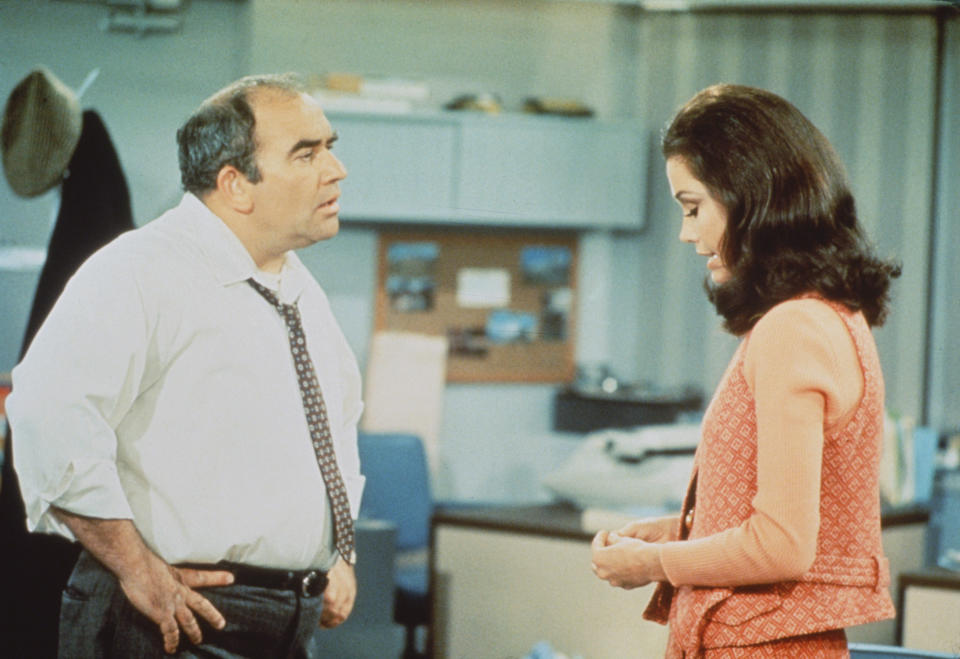 American actors Edward Asner (as Lou Grant) and Mary Tyler Moore (as Mary Richards) in a scene from 'The Mary Tyler Moore Show' (also known as 'Mary Tyler Moore'), Los Angeles, California, 1970. (CBS Photo Archive / Getty Images)