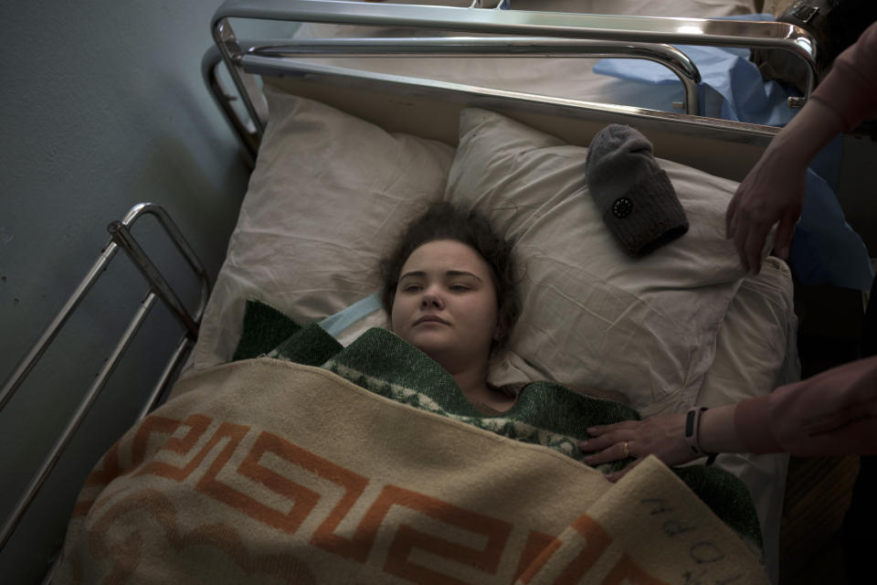 Katya, 14-years-old, is treated in a hospital after being shot while fleeing with her family from a village near Brovary, north of Kyiv, Ukraine, Thursday, March 10, 2022. (AP Photo/Felipe Dana)