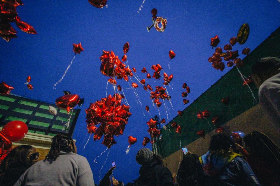 Balloons are released into the night sky during a vigil for Quillan Jacobs on Friday evening outside of the Second Baptist Church in downtown Columbia.