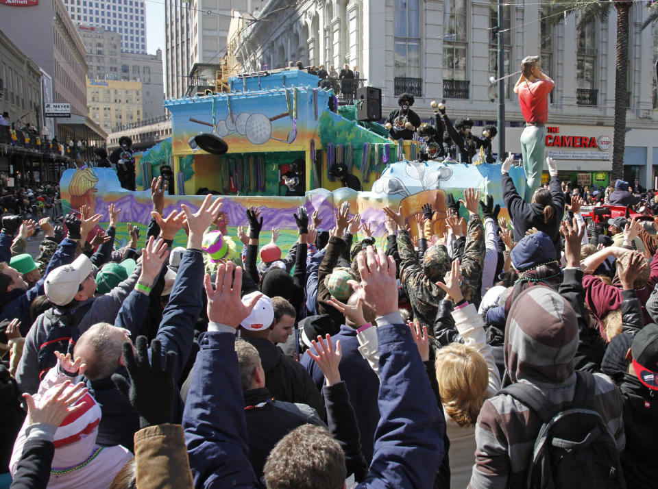 FILE - In this Feb. 16, 2010 file photo, the Zulu Mardi Gras parade makes its way onto Canal Street in the Central Business District in New Orleans. New Orleans is perhaps best-known for hosting one of the biggest free parties in the world: Mardi Gras. The Carnival season includes parades with costumed riders, marching bands and decorated floats. (AP Photo/Bill Haber, file)