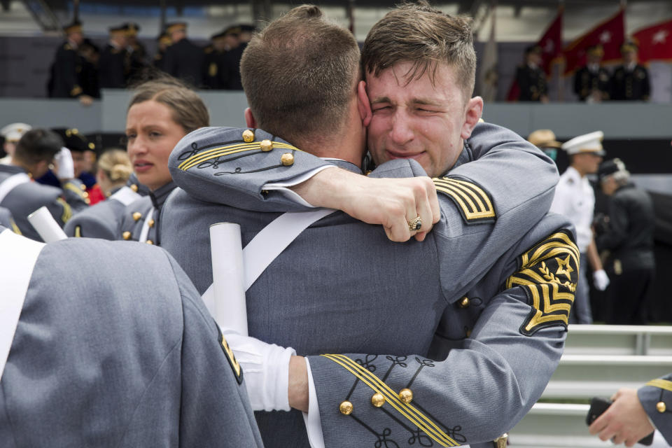 West Point cadets hug each other at the end of graduation ceremonies at the United States Military Academy in West Point, N.Y., on Saturday, May 25, 2019. (AP Photo/Julius Constantine Motal)