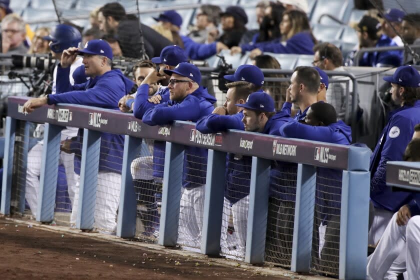 Los Angeles, CA - October 20: The Los Angeles Dodgers bench watches from the dugout during the ninth inning.