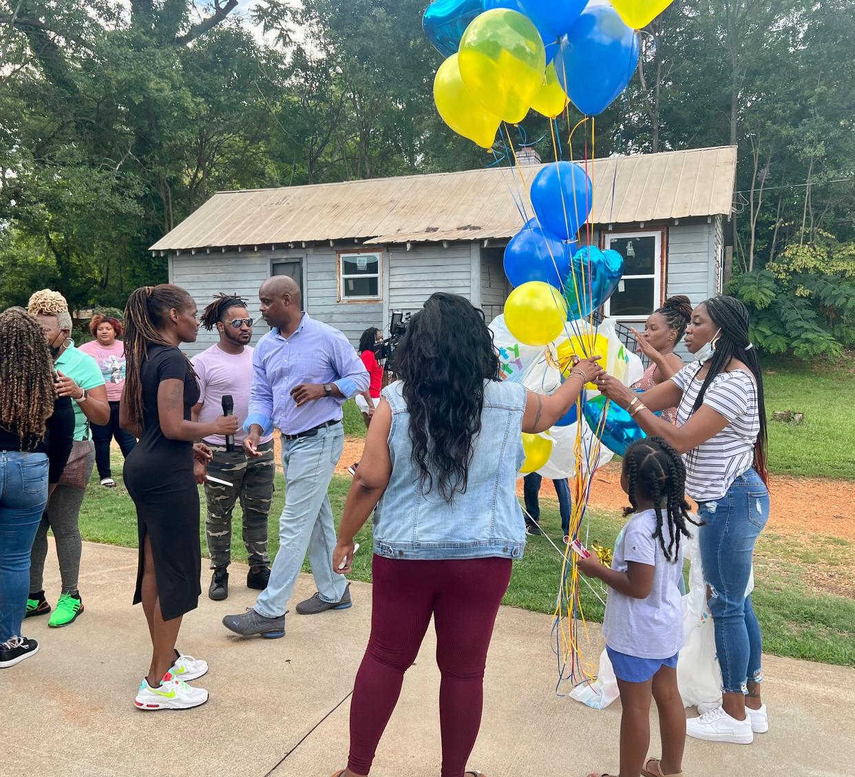 Attendees honor the memory of Susan Elaine Donald on Saturday, Aug. 6, 2022, outside of the house where her body was found.