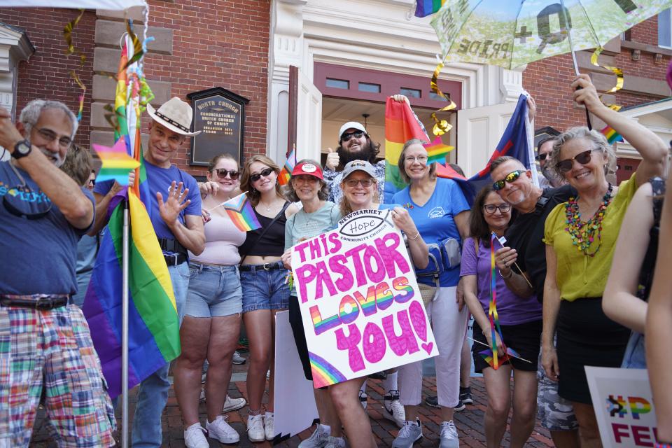 A Newmarket Community Church group, with pastor Patty Marsden (in middle with sign), participates in the Portsmouth Pride celebration Saturday, June 25, 2022.