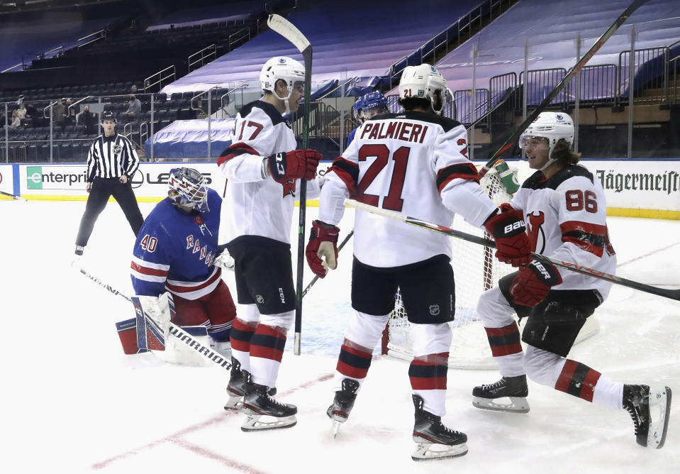 New Jersey Devils' Jack Hughes, right, celebrates his goal against the New York Rangers during the second period of an NHL hockey game Tuesday, Jan. 19, 2021, in New York. (Bruce Bennett/Pool Photo via AP)