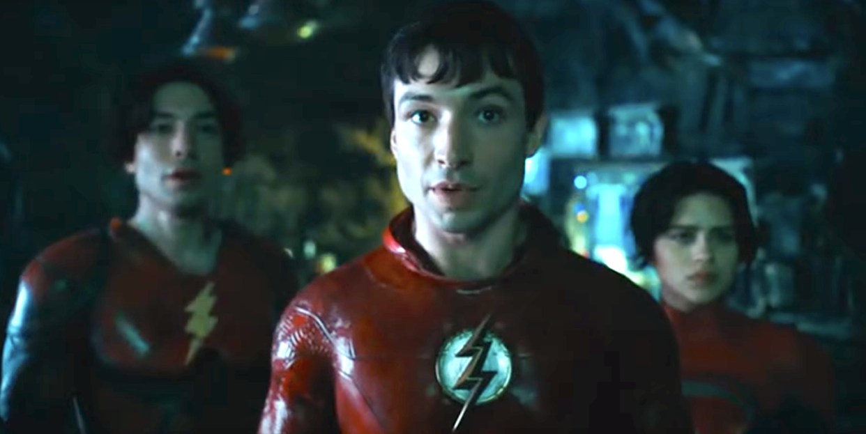 ezra miller wearing red superhero costume with lightning bolt logo in the flash