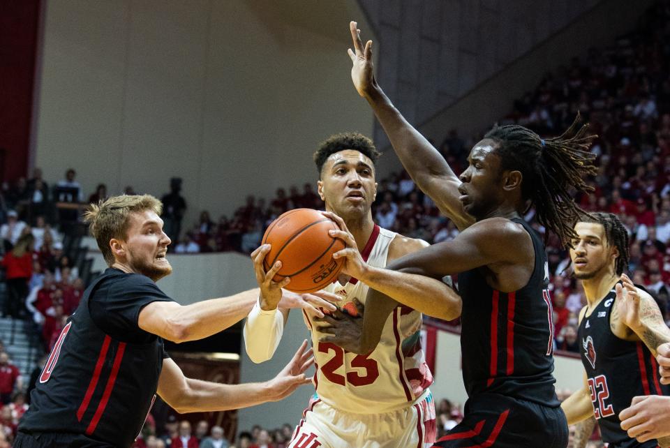 Indiana Hoosiers forward Trayce Jackson-Davis (23) shoots the ball while Rutgers Scarlet Knights guard Cam Spencer (10) and  center Clifford Omoruyi (11) defend in the first half  at Simon Skjodt Assembly Hall.