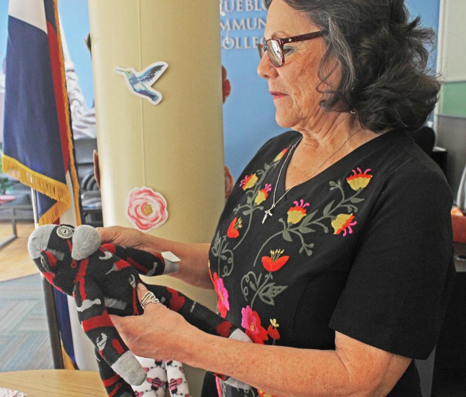 Jackie Jimenez checks out 'Tooly' the sock monkey which will be among goodies she and her sisters will sell at the Small Business Expo from 10 a.m. to 4 p.m. May 4 at Pueblo Community College's student center.