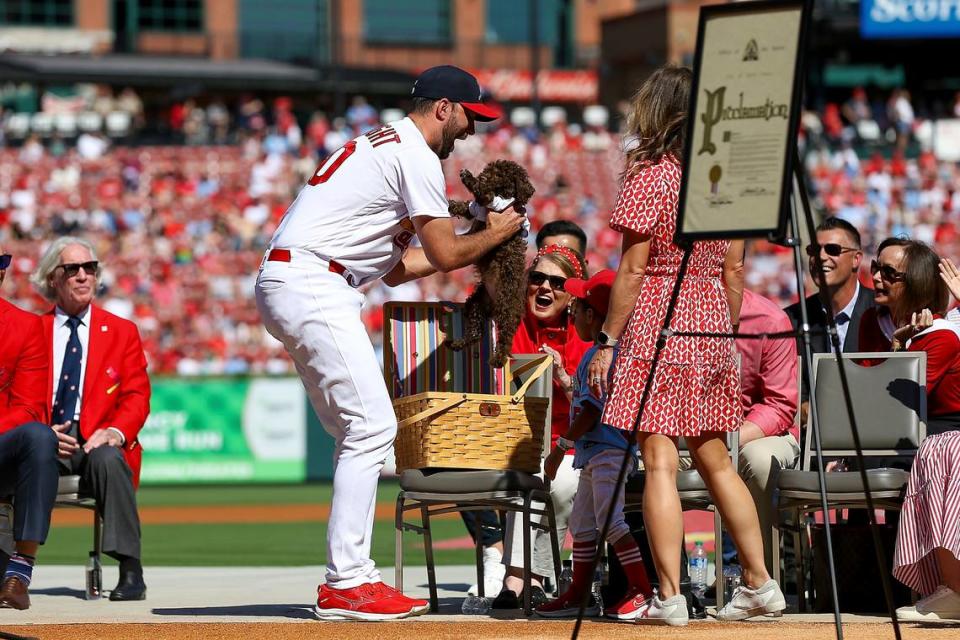 St. Louis Cardinals’ Adam Wainwright is gifted a puppy as he is honored during his retirement ceremony before the Cardinals’ final regular season baseball game Sunday, Oct. 1, 2023, against the Cincinnati Reds in St. Louis. (AP Photo/Scott Kane)
