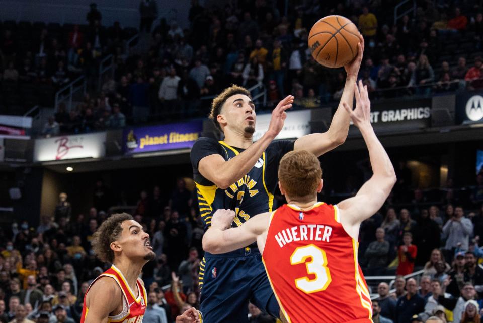 Dec 1, 2021; Indianapolis, Indiana, USA; Indiana Pacers guard Chris Duarte (3) shoots the ball while Atlanta Hawks guard Kevin Huerter (3) defends in the second half at Gainbridge Fieldhouse. Mandatory Credit: Trevor Ruszkowski-USA TODAY Sports