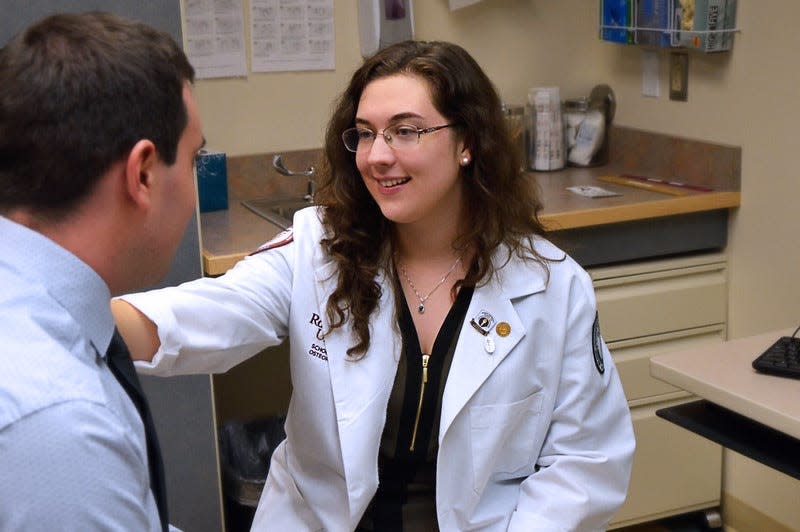 Before the coronavirus pandemic, a student at the Rowan University School of Osteopathic Medicine treats a patient during clinic hours. The deans of both of Rowan's medical schools are calling upon Gov. Phil Murphy to create a task force to best address the virus' threat of clinical hours in the face of a projected physician shortage.