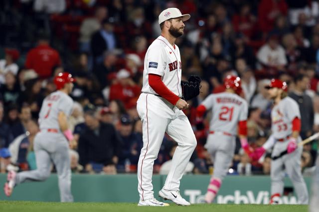 Boston Red Sox's Ryan Brasier walks back to the mound after giving up a two-run single to St. Louis Cardinals' Nolan Arenado that drove in Andrew Knizner (7) and Lars Nootbaar (21) during the sixth inning of a baseball game, Sunday, May 14, 2023, in Boston. (AP Photo/Michael Dwyer)