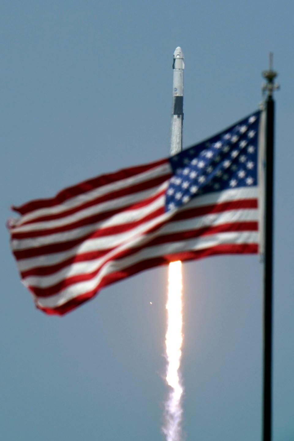 spacex falcon 9 rocket launch crew dragon endeavour spaceship nasa astronauts bob behnken doug hurley american us flag kennedy space center ksc AP_20151703843356