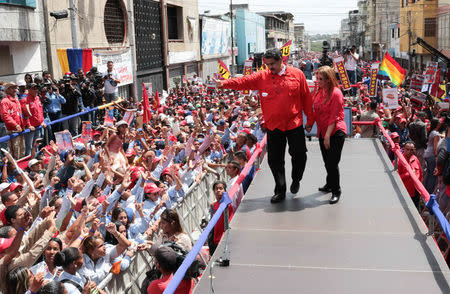 Venezuela's President Nicolas Maduro and his wife Cilia Flores greet supporters during a campaign rally in Ciudad Guayana, Venezuela April 23, 2018. Miraflores Palace/Handout via REUTERS