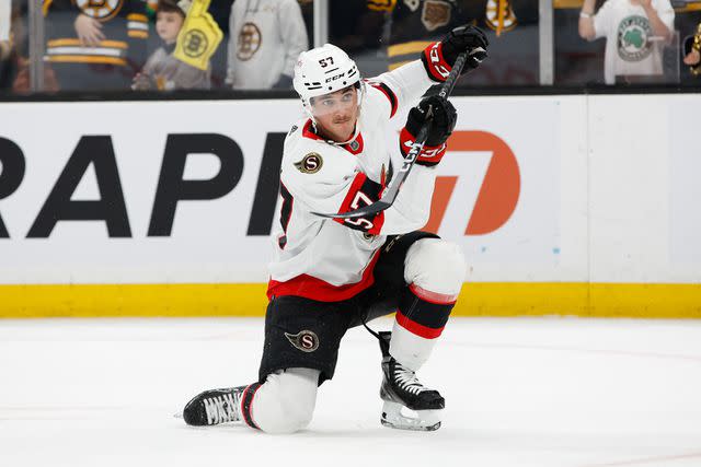 <p>Richard T Gagnon/Getty</p> Shane Pinto #57 of the Ottawa Senators warms up before a game against the Boston Bruins at the TD Garden on February 20, 2023 in Boston, Massachusetts.