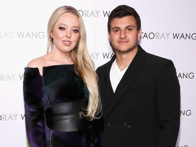 <p>Astrid Stawiarz/Getty</p> Tiffany Trump and Michael Boulos pose backstage for Taoray Wang fashion show on February 9, 2019 in New York City.