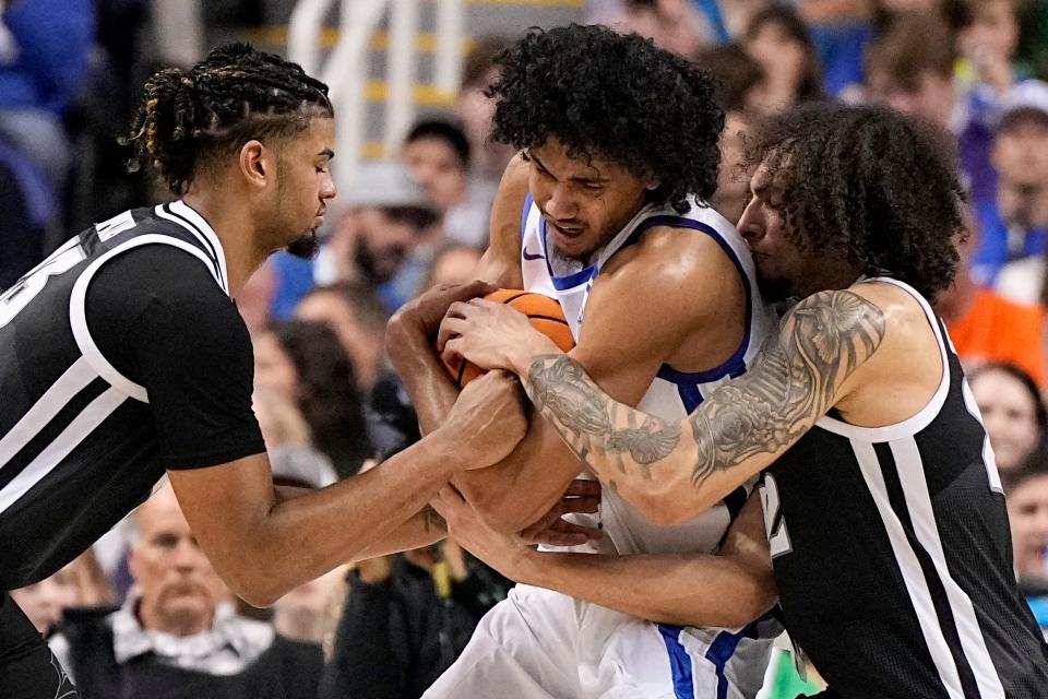 Providence forward Bryce Hopkins, left, and guard Devin Carter, right, battle for the ball with Kentucky's Jacob Toppin during an NCAA Tournament game in March. Despite a new coach, Hopkins and Carter both decided to remain at PC and play for the Friars this coming season.